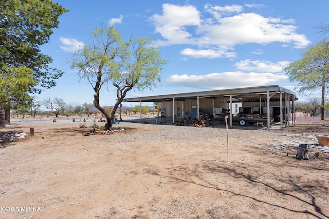 exterior space featuring a carport, an outdoor structure, and an outbuilding