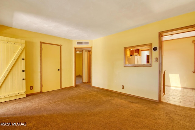 interior space featuring carpet, visible vents, and baseboards