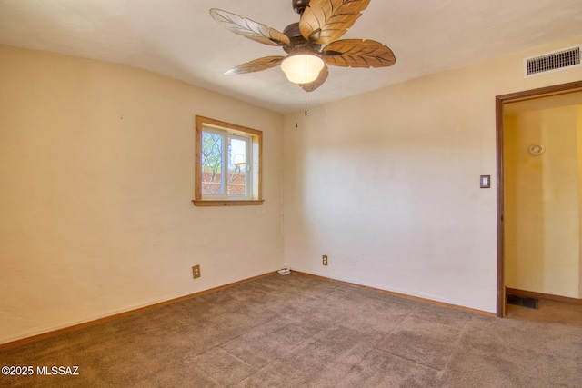 empty room with a ceiling fan, visible vents, and carpet floors