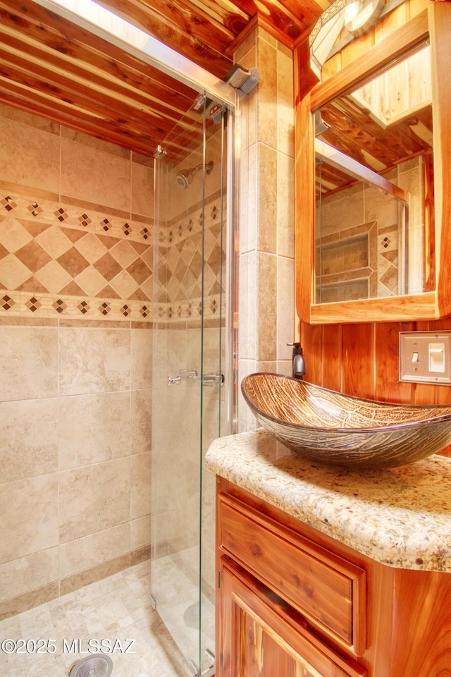 bathroom with vanity and a stall shower