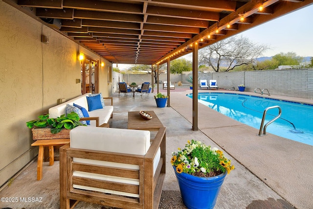 view of swimming pool featuring a patio area, a fenced backyard, an outdoor living space, and a fenced in pool