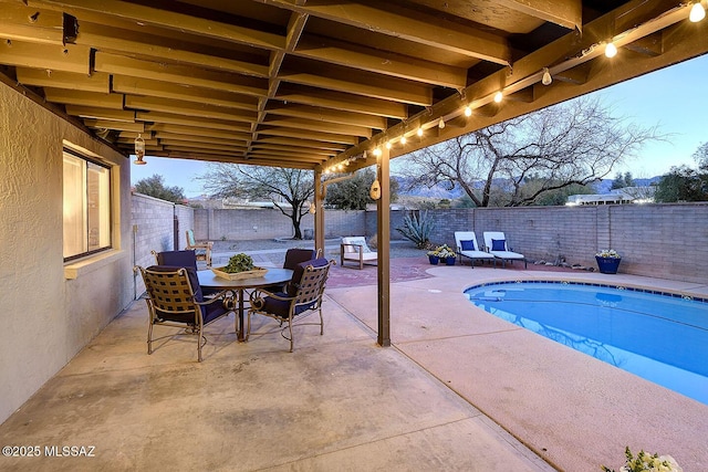 view of pool featuring a patio area, a fenced backyard, outdoor dining space, and a fenced in pool
