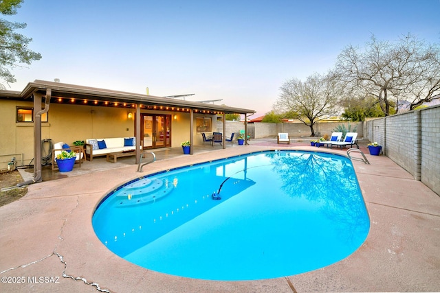 view of swimming pool with a fenced backyard, a fenced in pool, a patio, and an outdoor hangout area