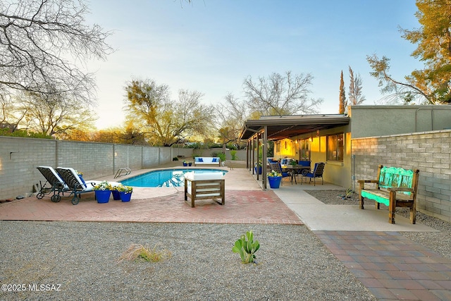 view of swimming pool featuring a fenced in pool, a patio area, and a fenced backyard