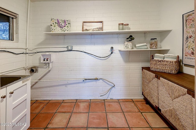 laundry room with light tile patterned floors, washer hookup, and cabinet space