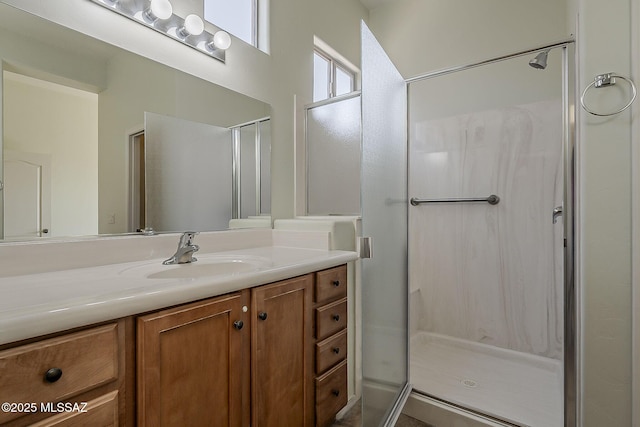 bathroom featuring a shower stall and vanity