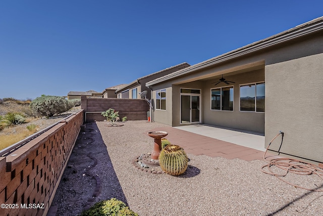 exterior space with a ceiling fan, fence, a patio, and stucco siding