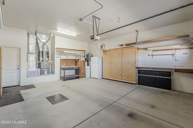 garage featuring a garage door opener, freestanding refrigerator, and water heater