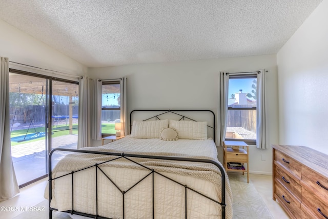 bedroom featuring access to outside and a textured ceiling