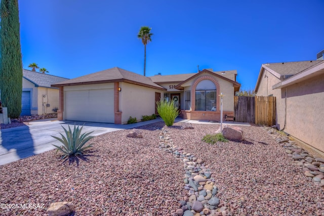single story home with fence, stucco siding, concrete driveway, brick siding, and a garage
