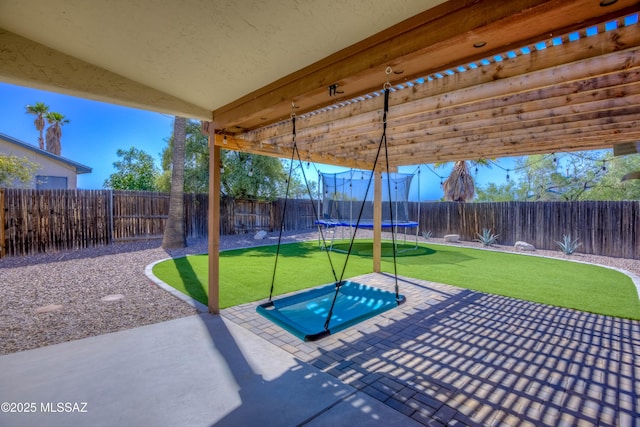 view of patio / terrace featuring a fenced backyard and a trampoline