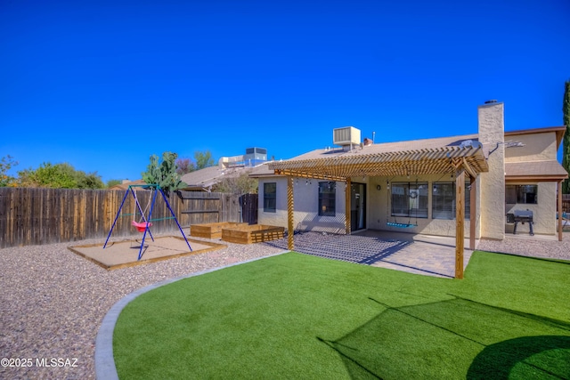 back of property with a pergola, a patio area, a playground, a fenced backyard, and stucco siding