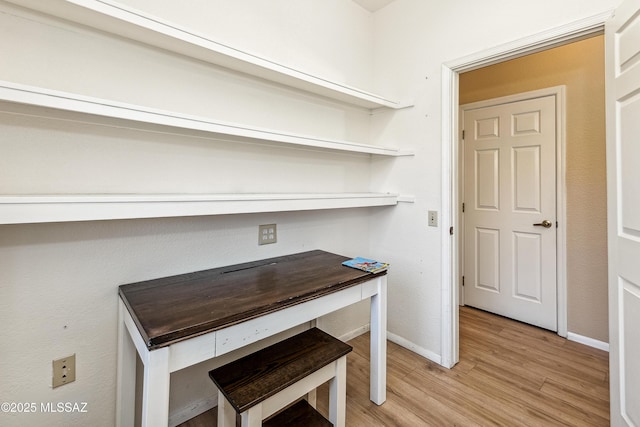 interior space featuring light wood-type flooring and baseboards