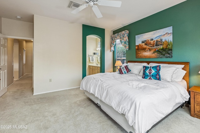 bedroom with visible vents, baseboards, ceiling fan, connected bathroom, and light carpet