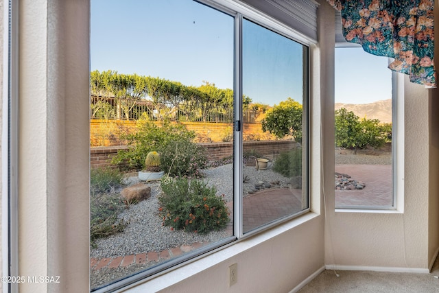 entryway featuring a mountain view, carpet floors, and baseboards