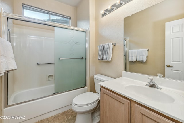 full bath with combined bath / shower with glass door, vanity, and toilet
