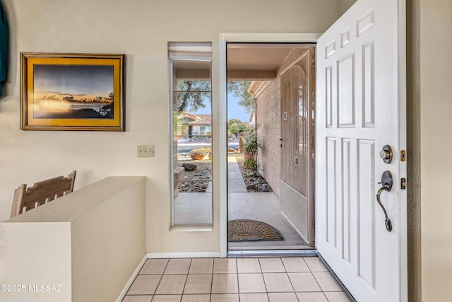 entryway featuring light tile patterned floors and baseboards