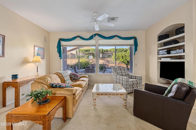 living room with plenty of natural light, carpet, visible vents, and ceiling fan