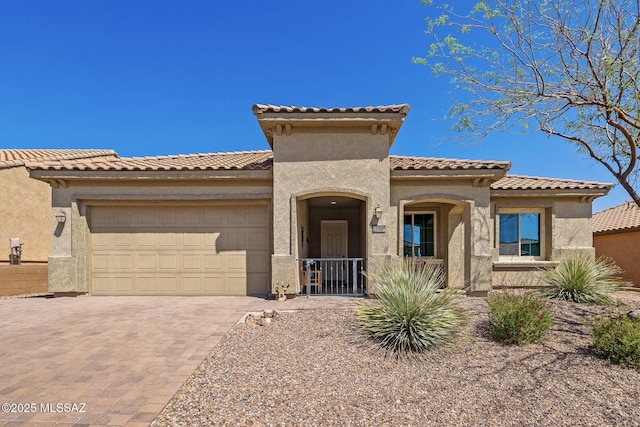 13906 N Rim Trl, Marana, AZ 85658 - mediterranean / spanish house with a garage, stucco siding, decorative driveway, and a tile roof