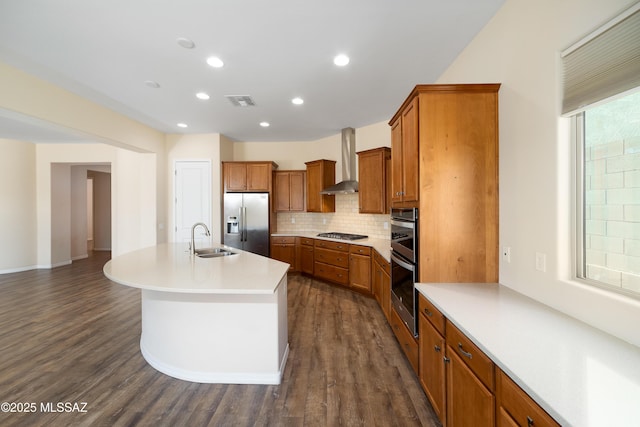13906 N Rim Trl, Marana, AZ 85658 - kitchen featuring appliances with stainless steel finishes, wall chimney range hood, a sink, brown cabinetry, and decorative backsplash