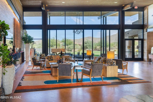 13906 N Rim Trl, Marana, AZ 85658 - community lobby featuring a towering ceiling, a wall of windows, and a mountain view