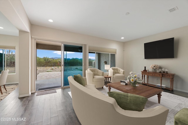 13906 N Rim Trl, Marana, AZ 85658 - living room featuring healthy amount of natural light, dark wood-style flooring, recessed lighting, and baseboards