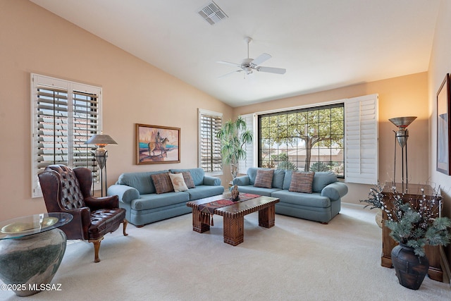 carpeted living area featuring lofted ceiling, visible vents, and ceiling fan