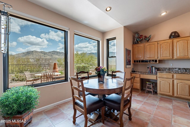 dining space with vaulted ceiling, recessed lighting, light tile patterned flooring, a mountain view, and baseboards