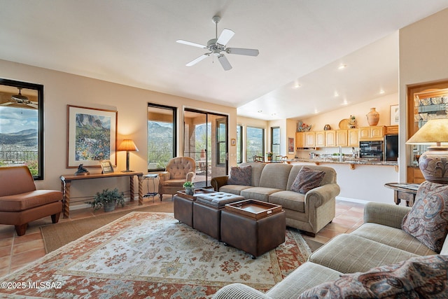 living room with lofted ceiling, light tile patterned flooring, and ceiling fan