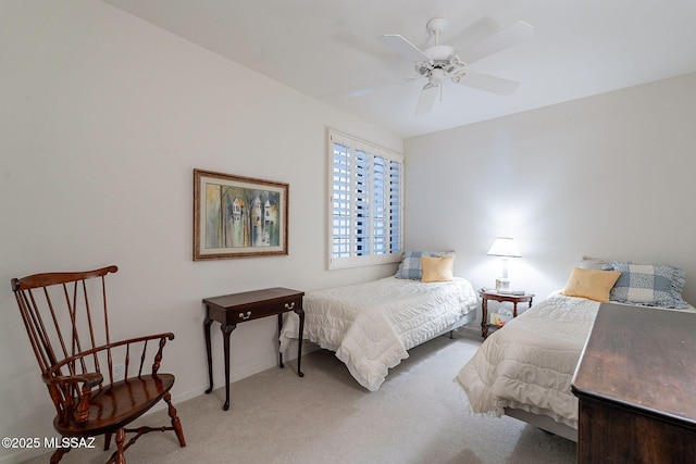 carpeted bedroom featuring baseboards and a ceiling fan
