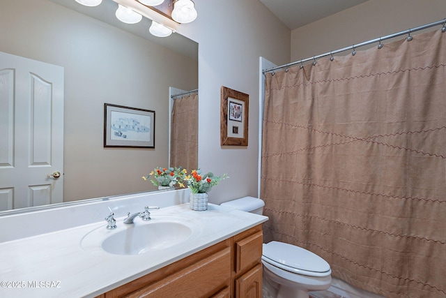bathroom with toilet, a shower with shower curtain, and vanity