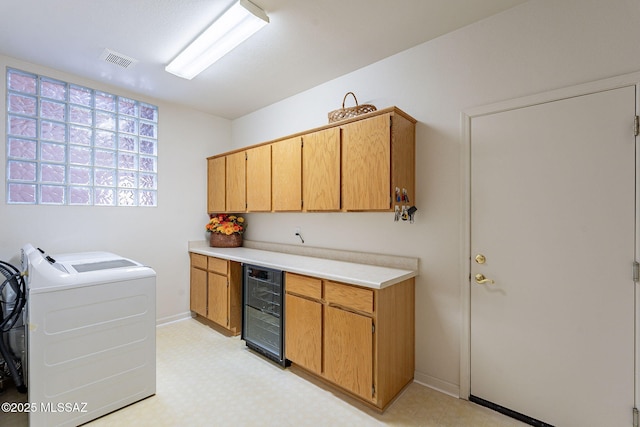 laundry room featuring visible vents, separate washer and dryer, cabinet space, beverage cooler, and light floors