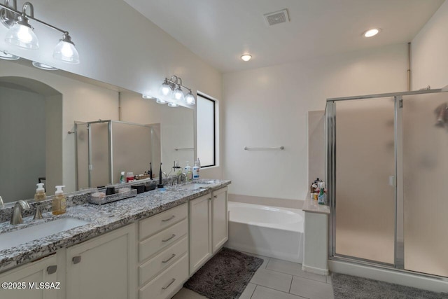 full bath featuring tile patterned floors, double vanity, visible vents, a stall shower, and a garden tub