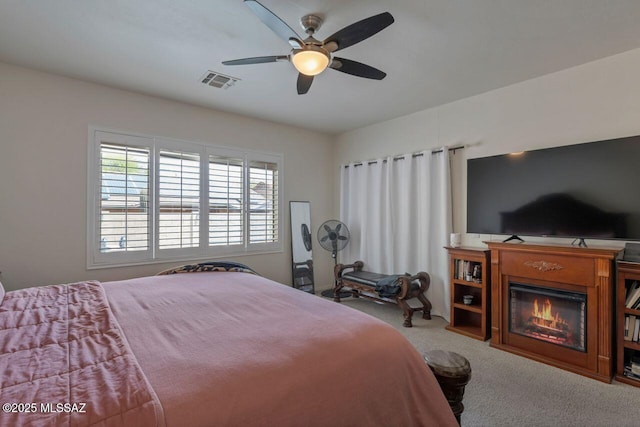 bedroom with visible vents, ceiling fan, and carpet flooring