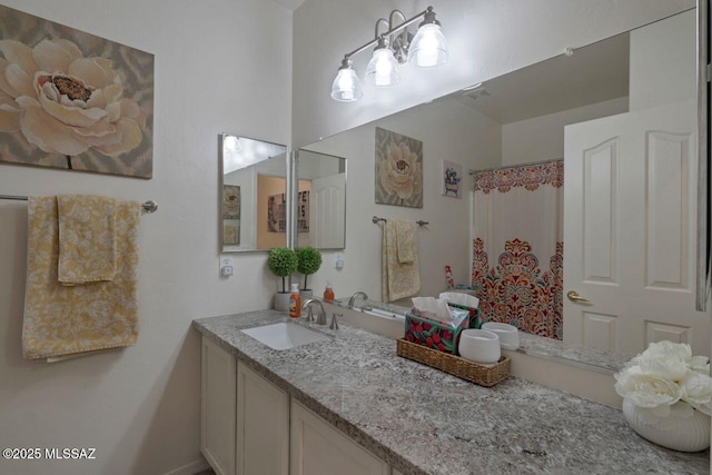 bathroom featuring vanity and a shower with shower curtain