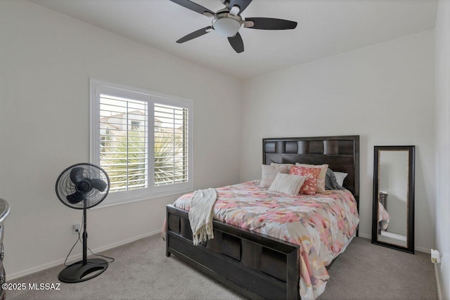 carpeted bedroom with ceiling fan and baseboards
