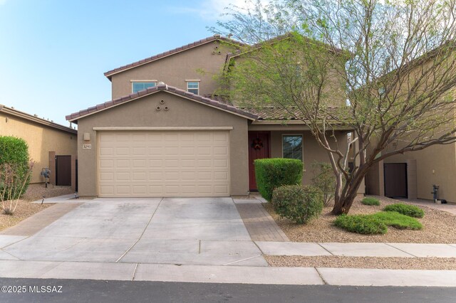 3295 W Sunlit Peak Dr, Tucson, AZ 85742 - view of front of home with driveway, stucco siding, a tiled roof, and an attached garage