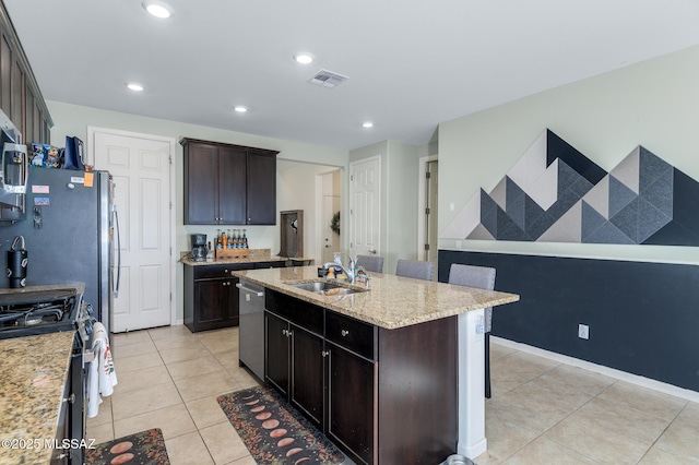 3295 W Sunlit Peak Dr, Tucson, AZ 85742 - kitchen with light tile patterned floors, visible vents, a kitchen island with sink, a sink, and stainless steel appliances