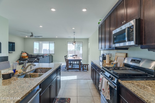 3295 W Sunlit Peak Dr, Tucson, AZ 85742 - kitchen featuring light carpet, a sink, light stone countertops, and stainless steel appliances
