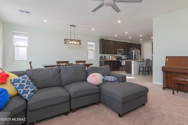 3295 W Sunlit Peak Dr, Tucson, AZ 85742 - living room with light colored carpet, ceiling fan, visible vents, and recessed lighting