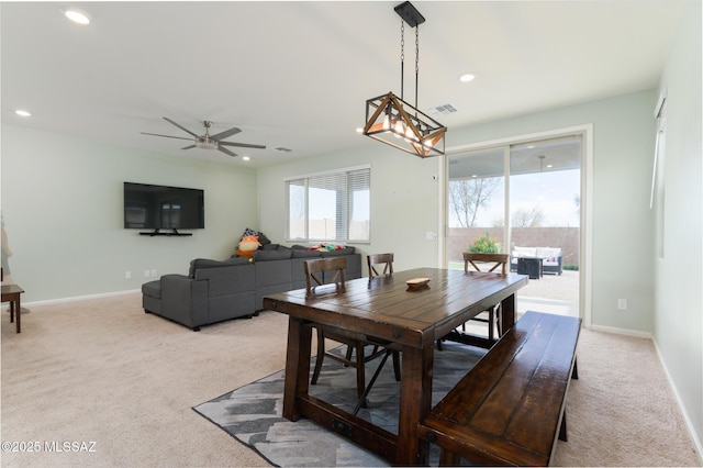 3295 W Sunlit Peak Dr, Tucson, AZ 85742 - dining area featuring baseboards, recessed lighting, light colored carpet, and ceiling fan with notable chandelier