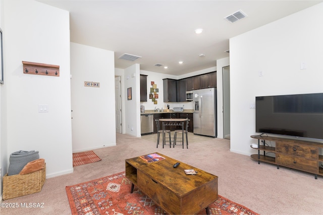 3295 W Sunlit Peak Dr, Tucson, AZ 85742 - living area with visible vents, light colored carpet, and baseboards