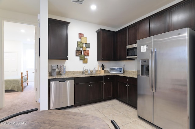 3295 W Sunlit Peak Dr, Tucson, AZ 85742 - kitchen featuring a sink, dark brown cabinetry, recessed lighting, light stone countertops, and stainless steel appliances