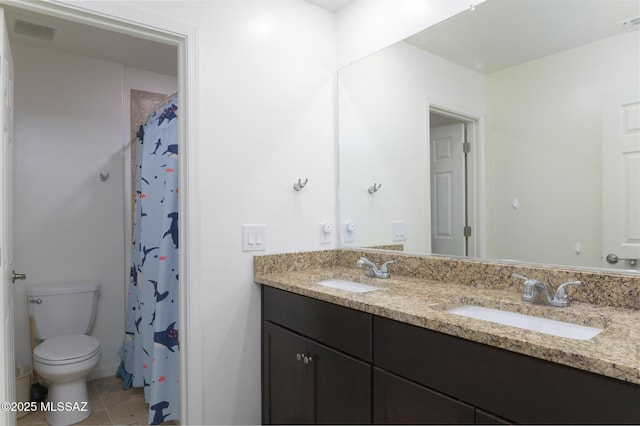 3295 W Sunlit Peak Dr, Tucson, AZ 85742 - bathroom featuring a sink, toilet, double vanity, and tile patterned flooring