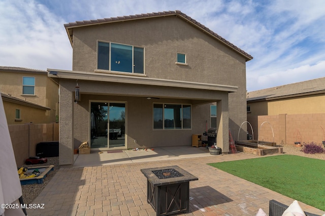 3295 W Sunlit Peak Dr, Tucson, AZ 85742 - back of house featuring a patio area, a fenced backyard, a fire pit, and stucco siding