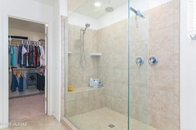 3295 W Sunlit Peak Dr, Tucson, AZ 85742 - bathroom with a shower stall, tile patterned flooring, and a spacious closet