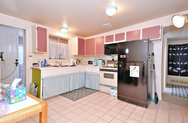 kitchen featuring light countertops, black appliances, a sink, visible vents, and light tile patterned flooring