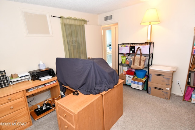 office area featuring visible vents and light carpet