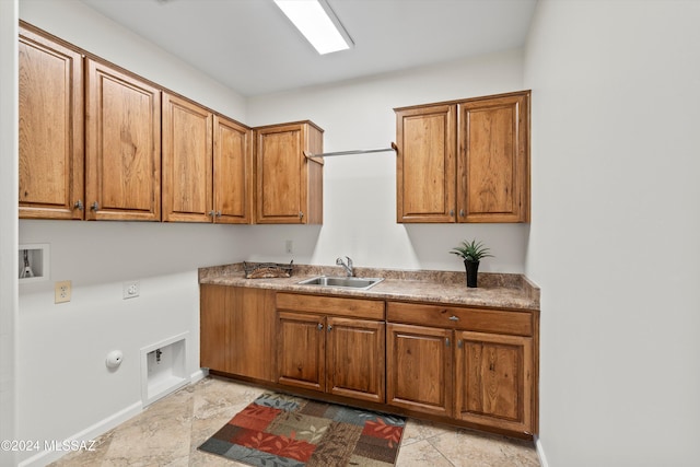 laundry area with hookup for a washing machine, hookup for an electric dryer, gas dryer hookup, a sink, and cabinet space