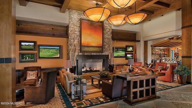 living room with a fireplace, wooden ceiling, and beamed ceiling